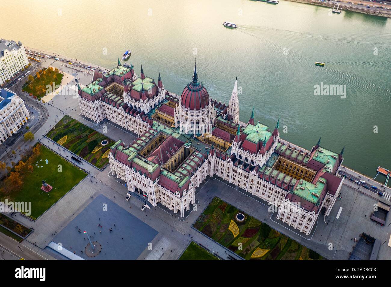 Budapest, Hungary - Aerial drone view of the beautiful Parliament of Hungary at sunset with golden lights on River Danube, sightseeing boats and tradi Stock Photo