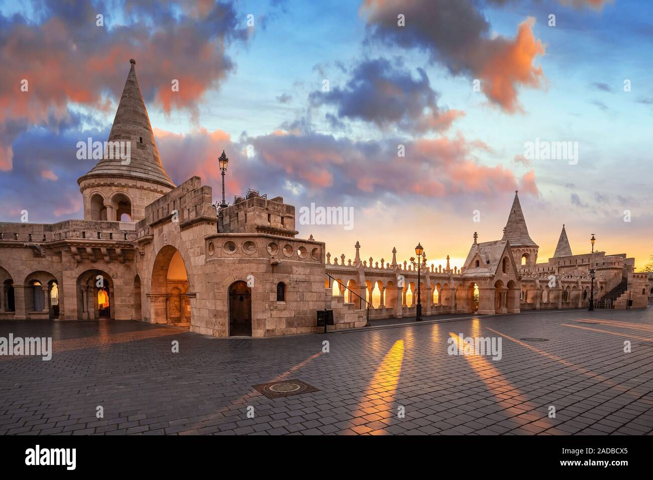 Budapest, Hungary - Beautiful autumn sunrise at Castle district and Fisherman's Bastion with warm sunlight and orange and blue sky and clouds Stock Photo