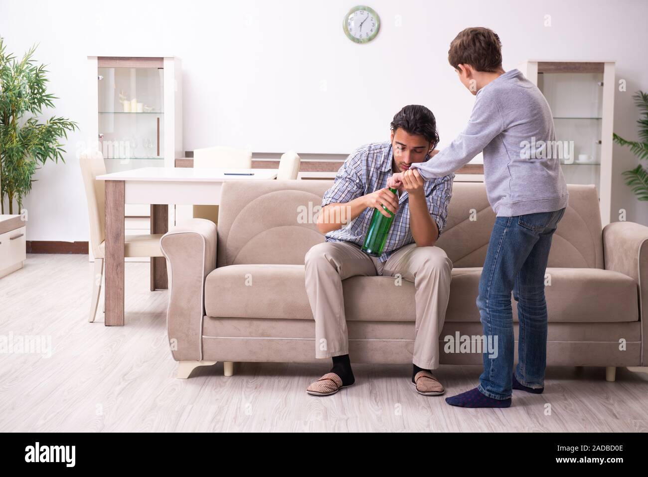 Drunk father and his son Stock Photo