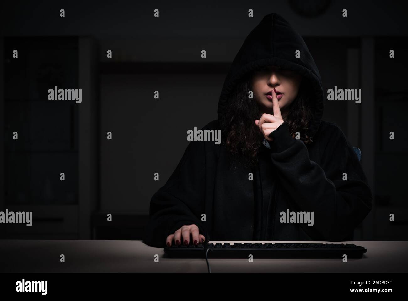 Female hacker hacking security firewall late in office Stock Photo