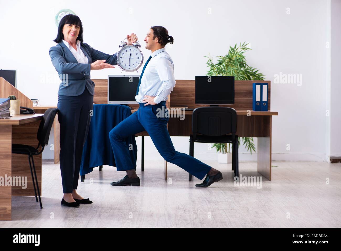Male employee doing sport exercises in the office Stock Photo