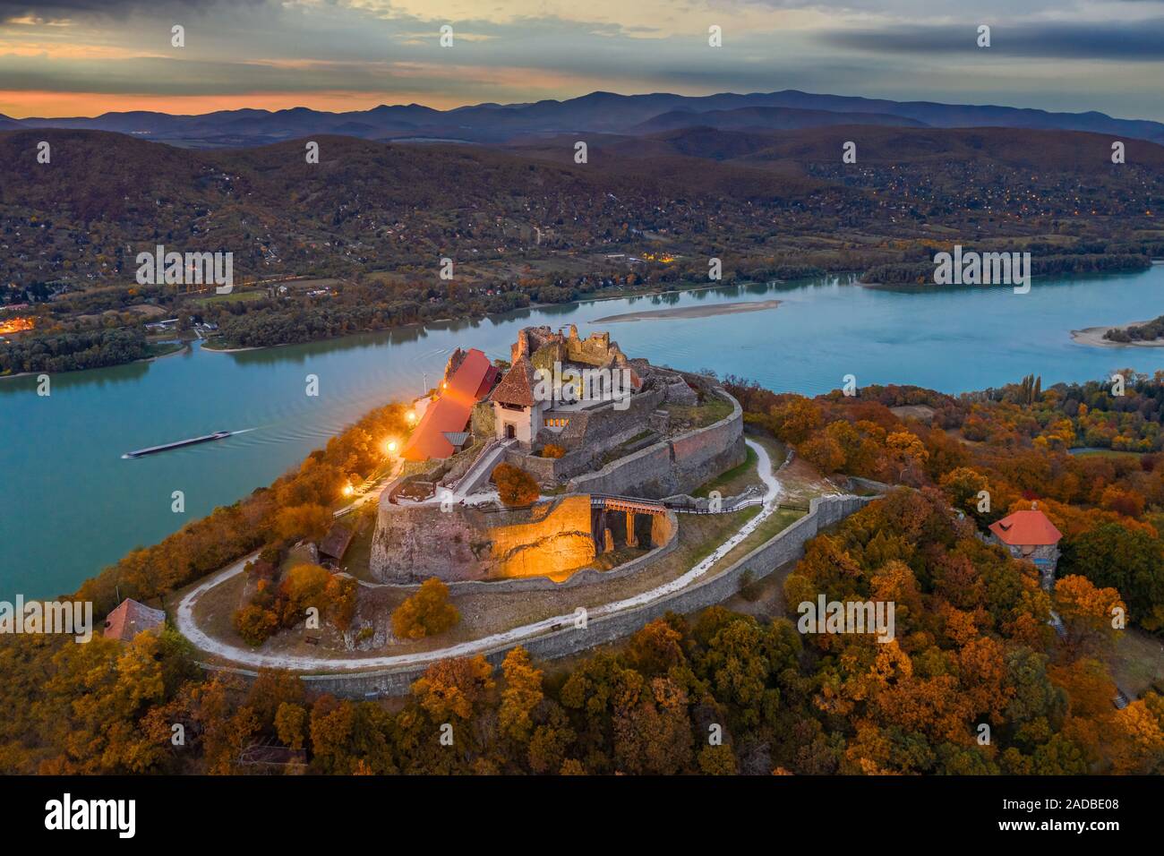 Visegrad, Hungary - Autumn from above at Visegrad. Aerial drone view of the beautiful high castle of Visegrad with colorful sunset and Dunakanyar at b Stock Photo