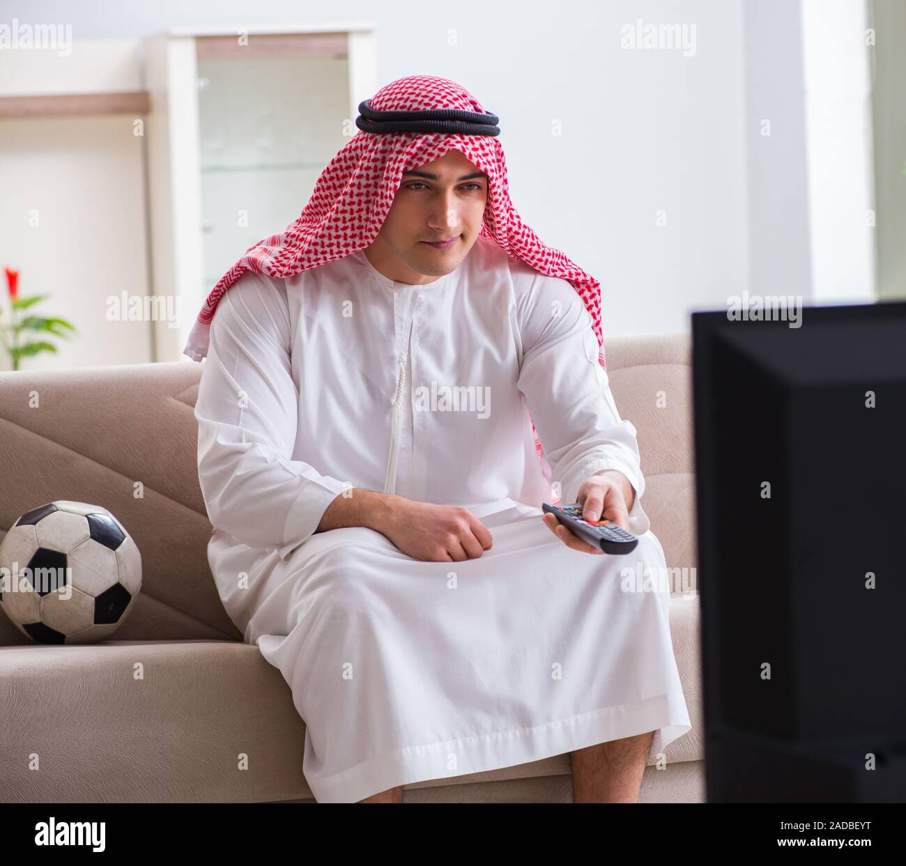 Arab Businessman watching tv at home Stock Photo