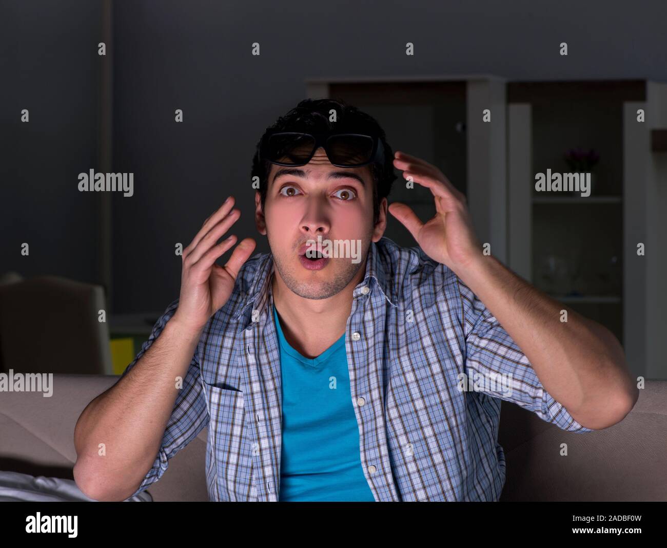Man watching 3d television late at night Stock Photo Alamy