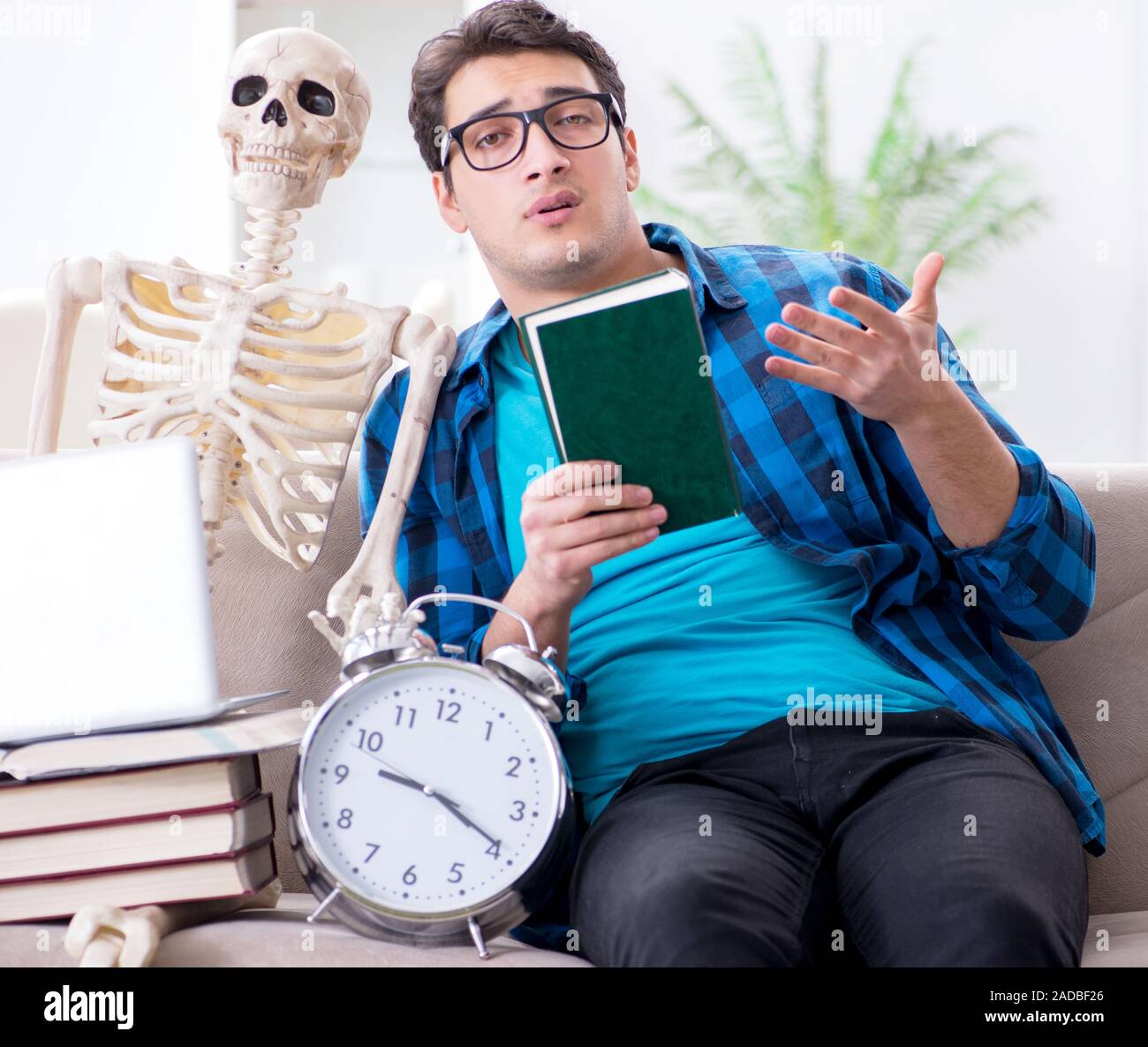 Student studying with skeleton preparing for exams Stock Photo