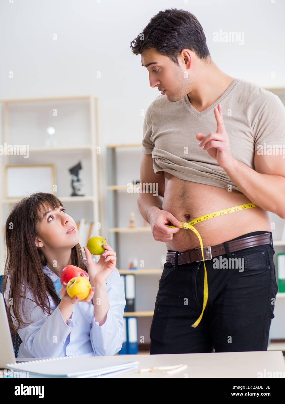 Doctor dietician giving advices to fat overweight patient Stock Photo