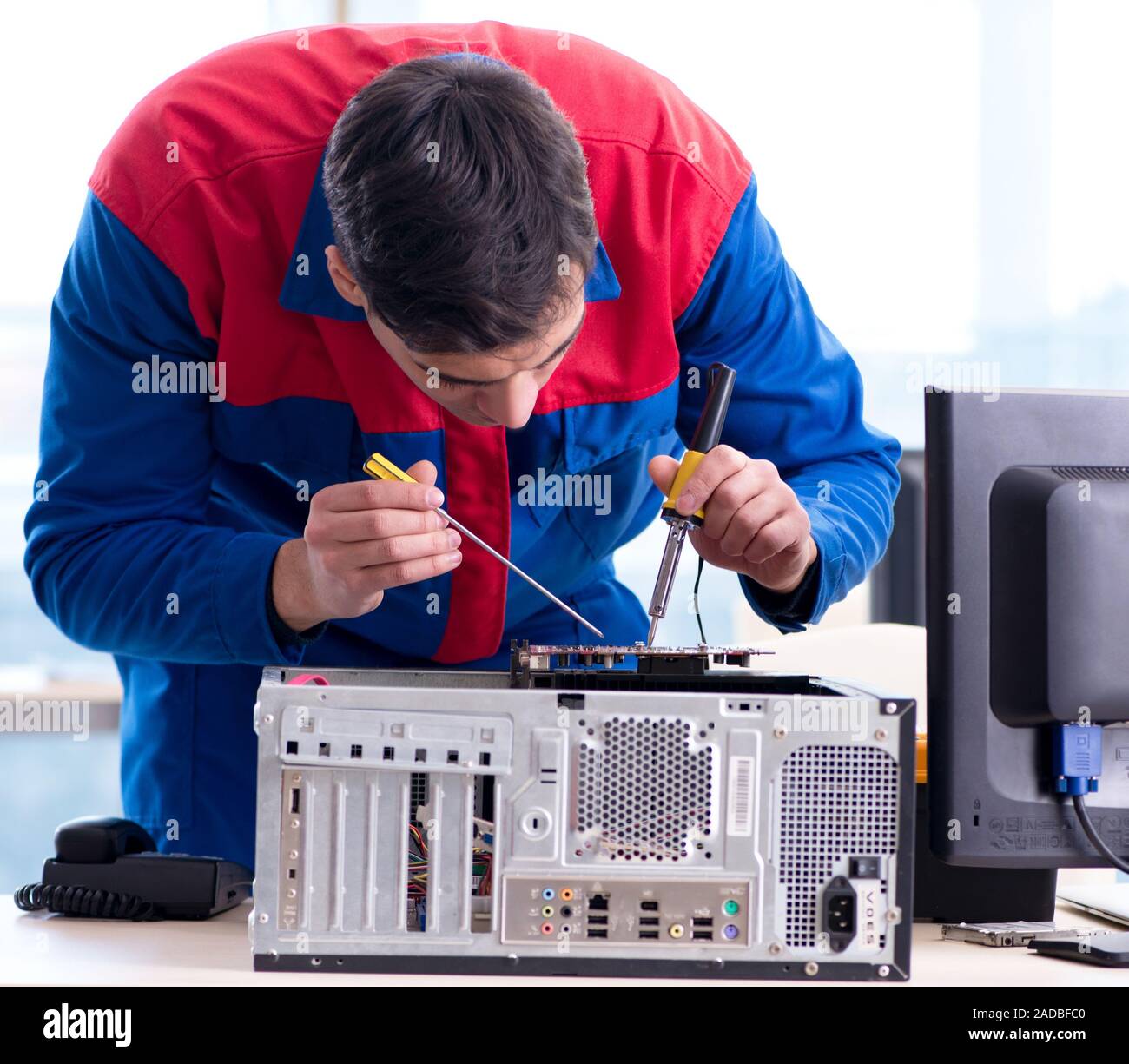Computer repairman specialist repairing computer desktop Stock Photo