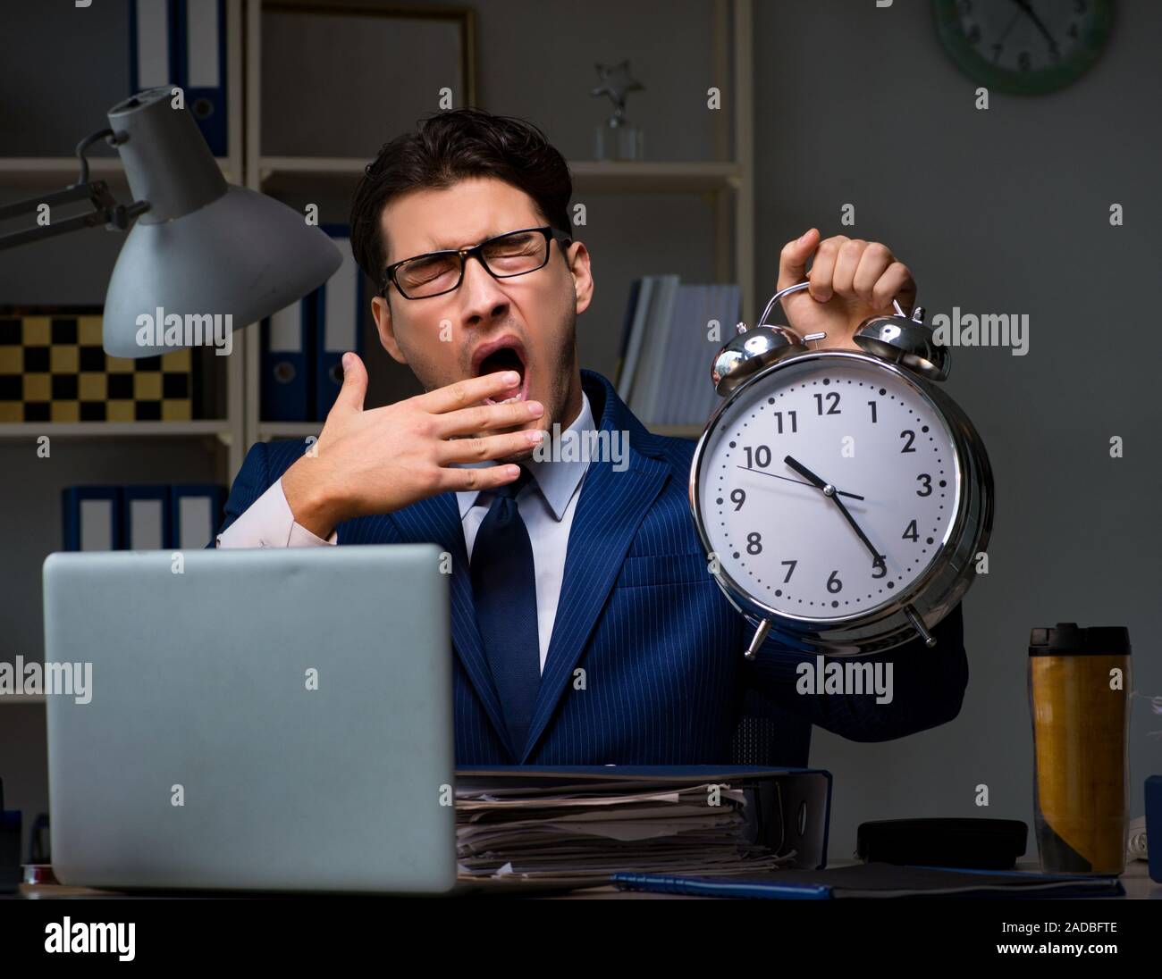 Businessman falling asleep during long hours in office Stock Photo Alamy