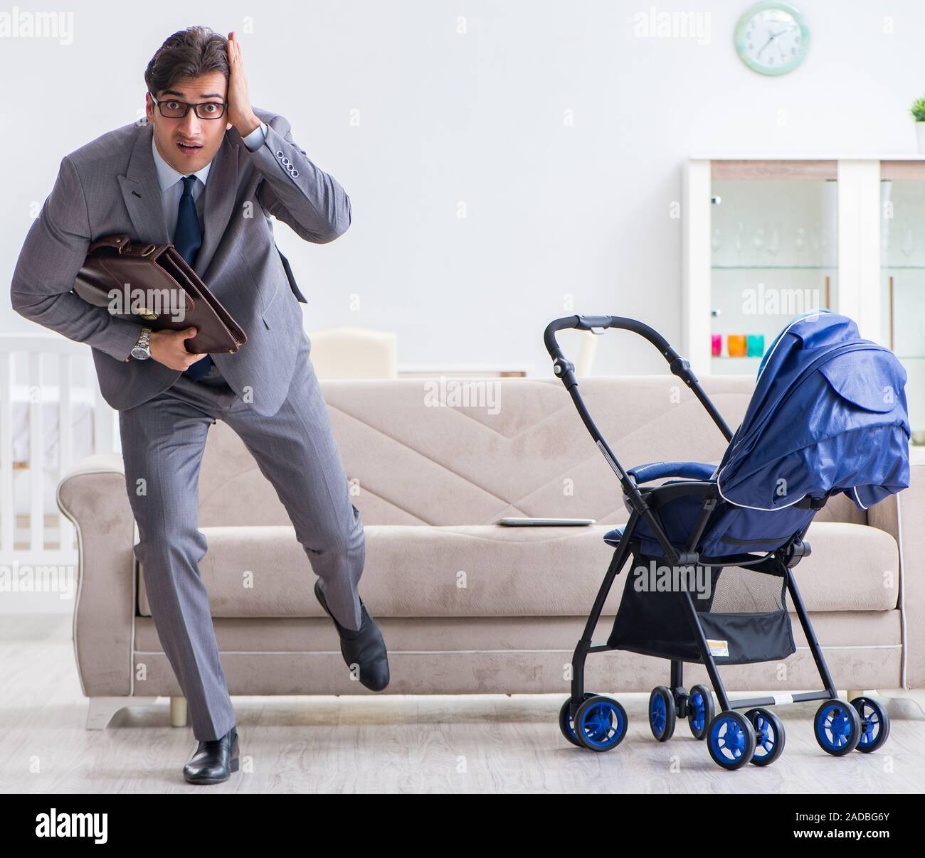Businessman Looking After Newborn Baby At Home And Teleworking Stock 