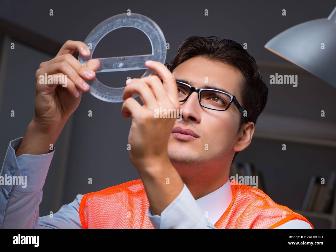 Construction architect working on drawings late at night Stock Photo