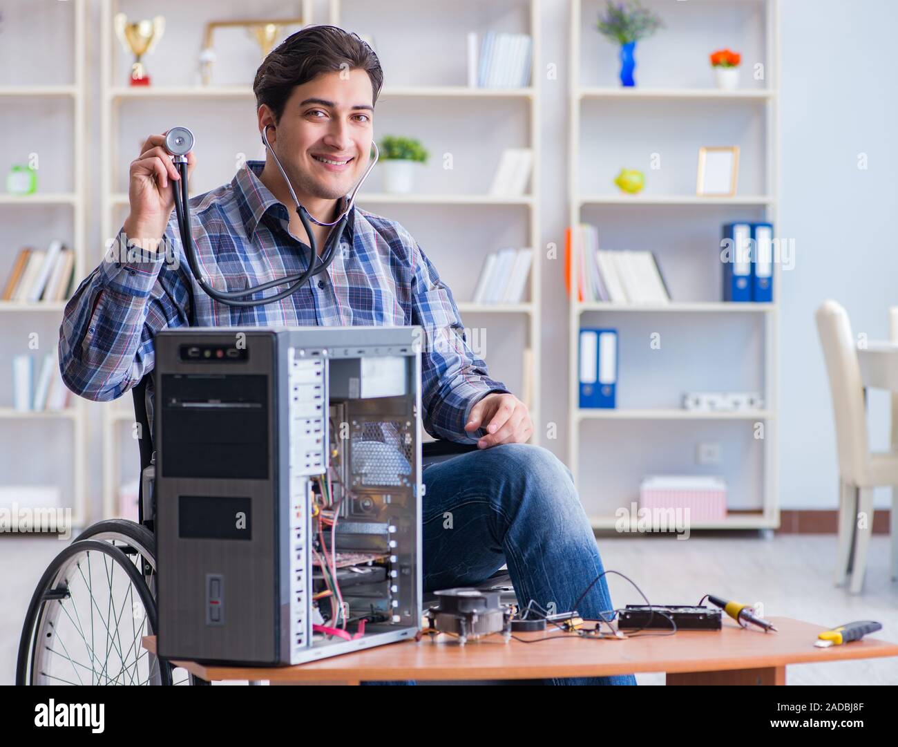 Computer repairman on wheelchair working Stock Photo