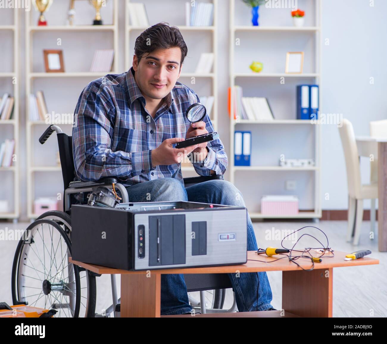 Computer repairman on wheelchair working Stock Photo Alamy