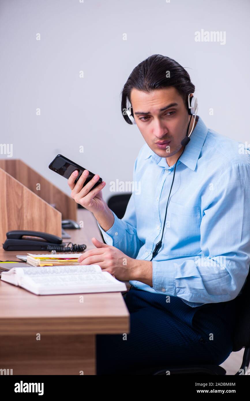 Call center operator working at his desk Stock Photo - Alamy