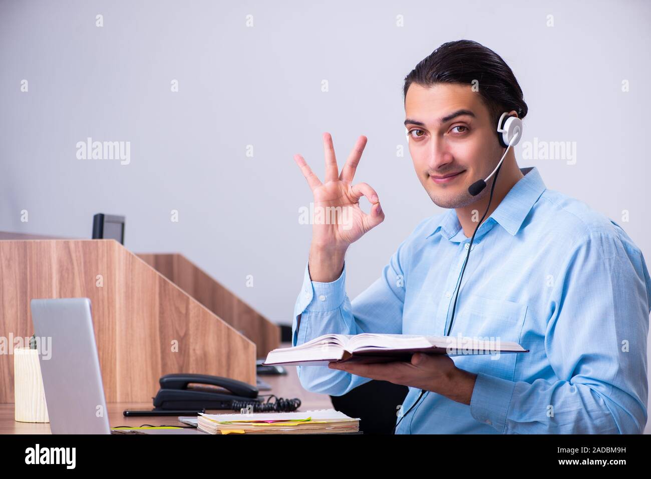 Call center operator working at his desk Stock Photo - Alamy