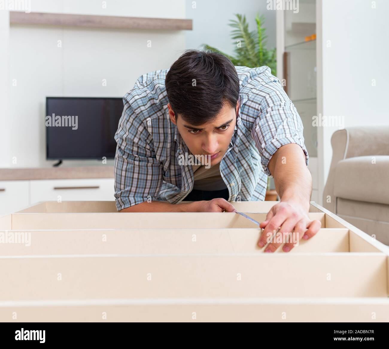 Man assembling furniture at home Stock Photo Alamy