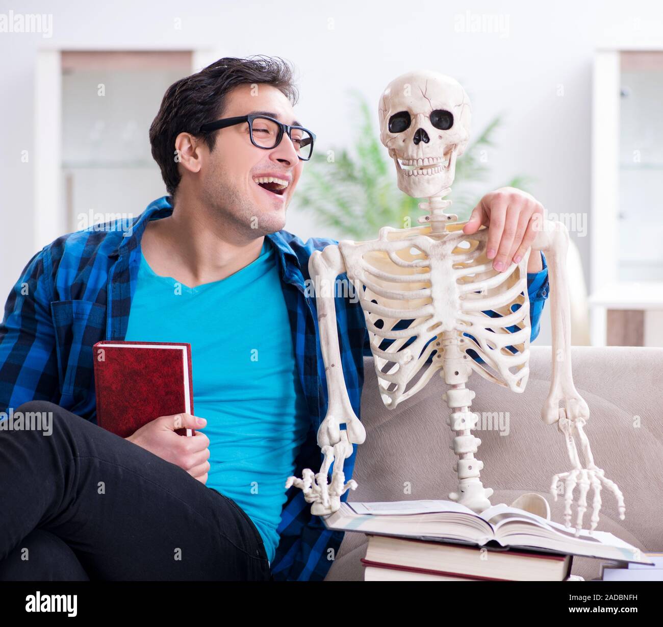 Student studying with skeleton preparing for exams Stock Photo