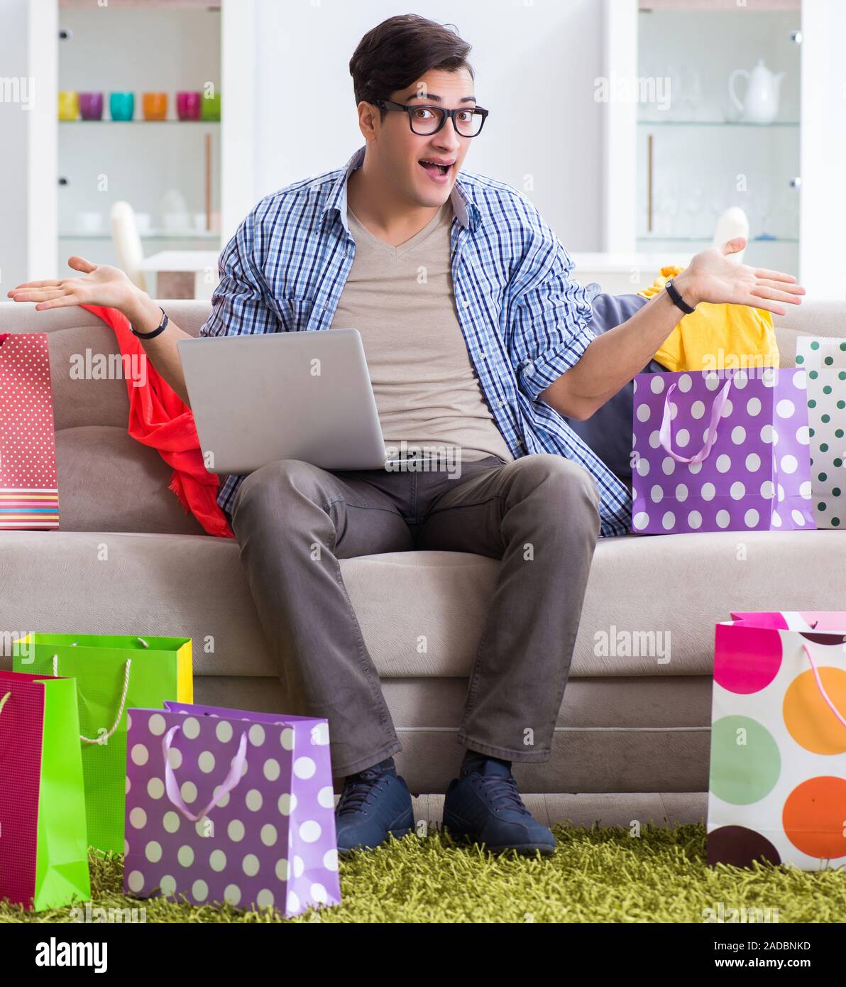 The young man buying clothing online and running blog Stock Photo