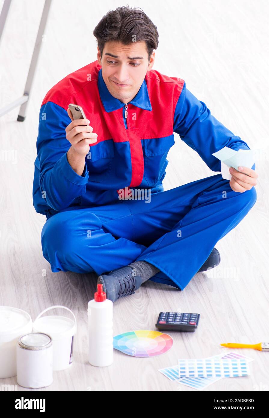 Young painter trying to match colours for painting job Stock Photo Alamy