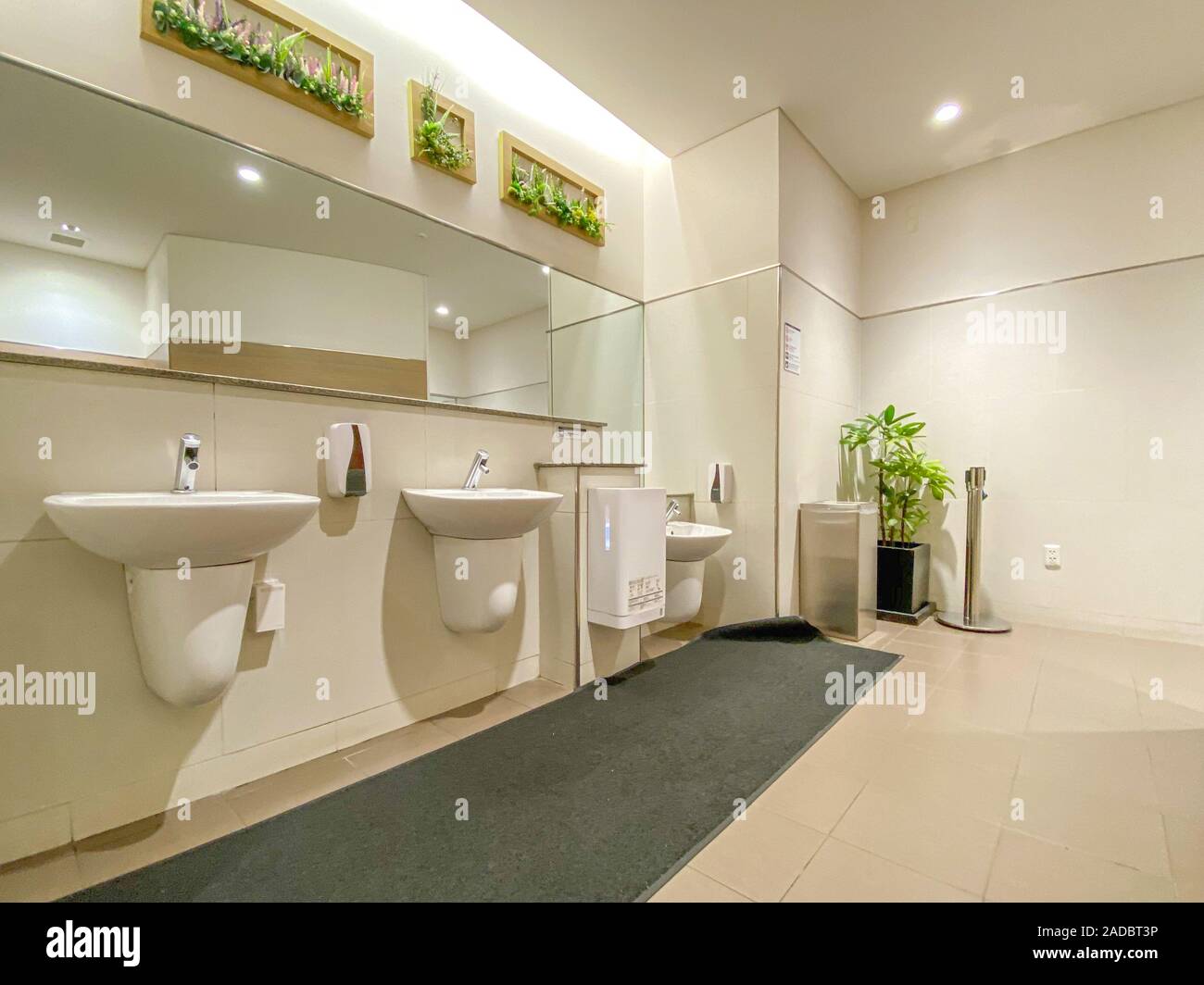 Mirrors and washbasin in empty public restroom Stock Photo Alamy