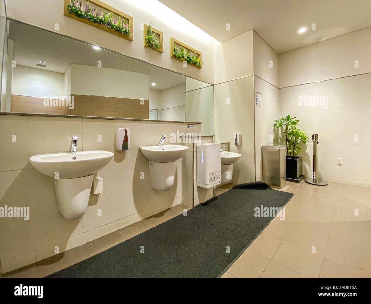 Faucets and mirrors with washbasin in public restroom Stock Photo Alamy