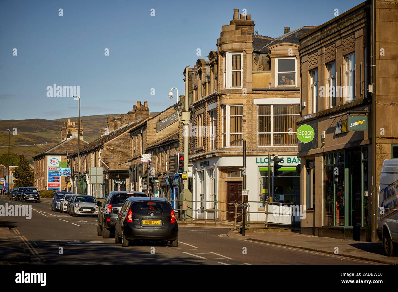 Glossop market town, the High Peak, Derbyshire, England.  The A57 High Street lived with terraced shops Stock Photo