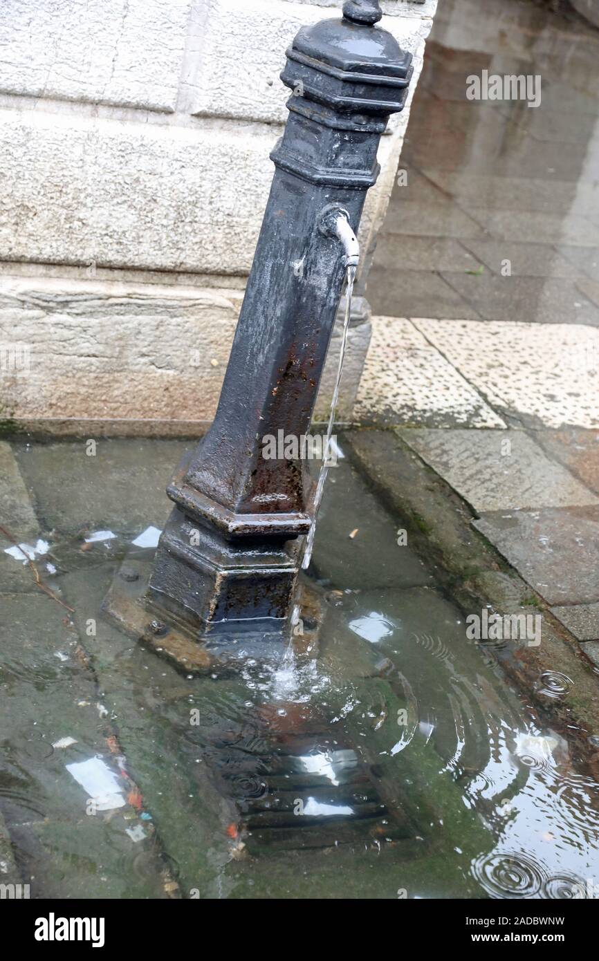 fountain with the drain of the manhole clogged and all the water that