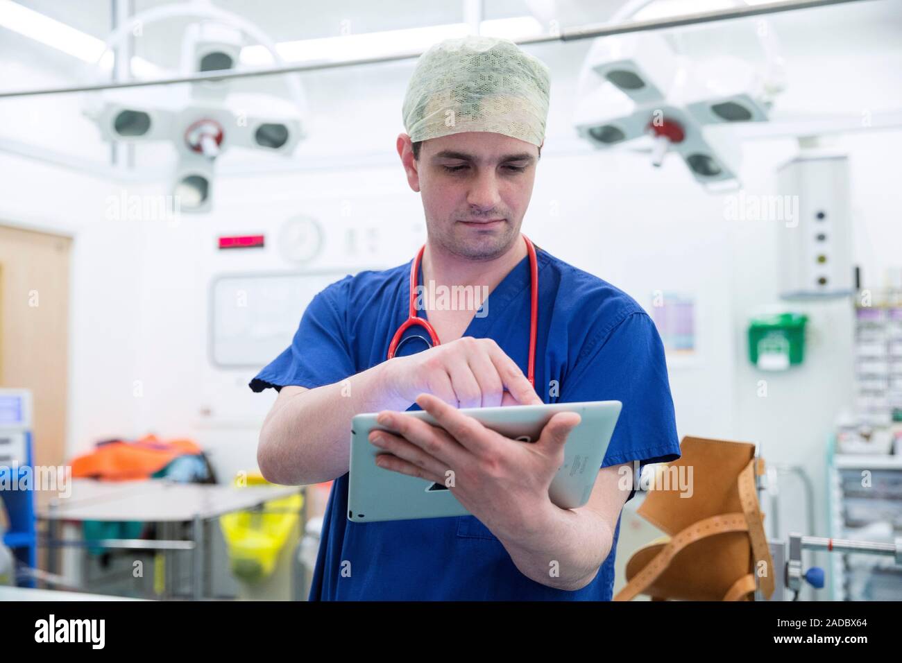 Doctor using tablet computer. Doctor using a tablet computer while at work in a hospital. Stock Photo