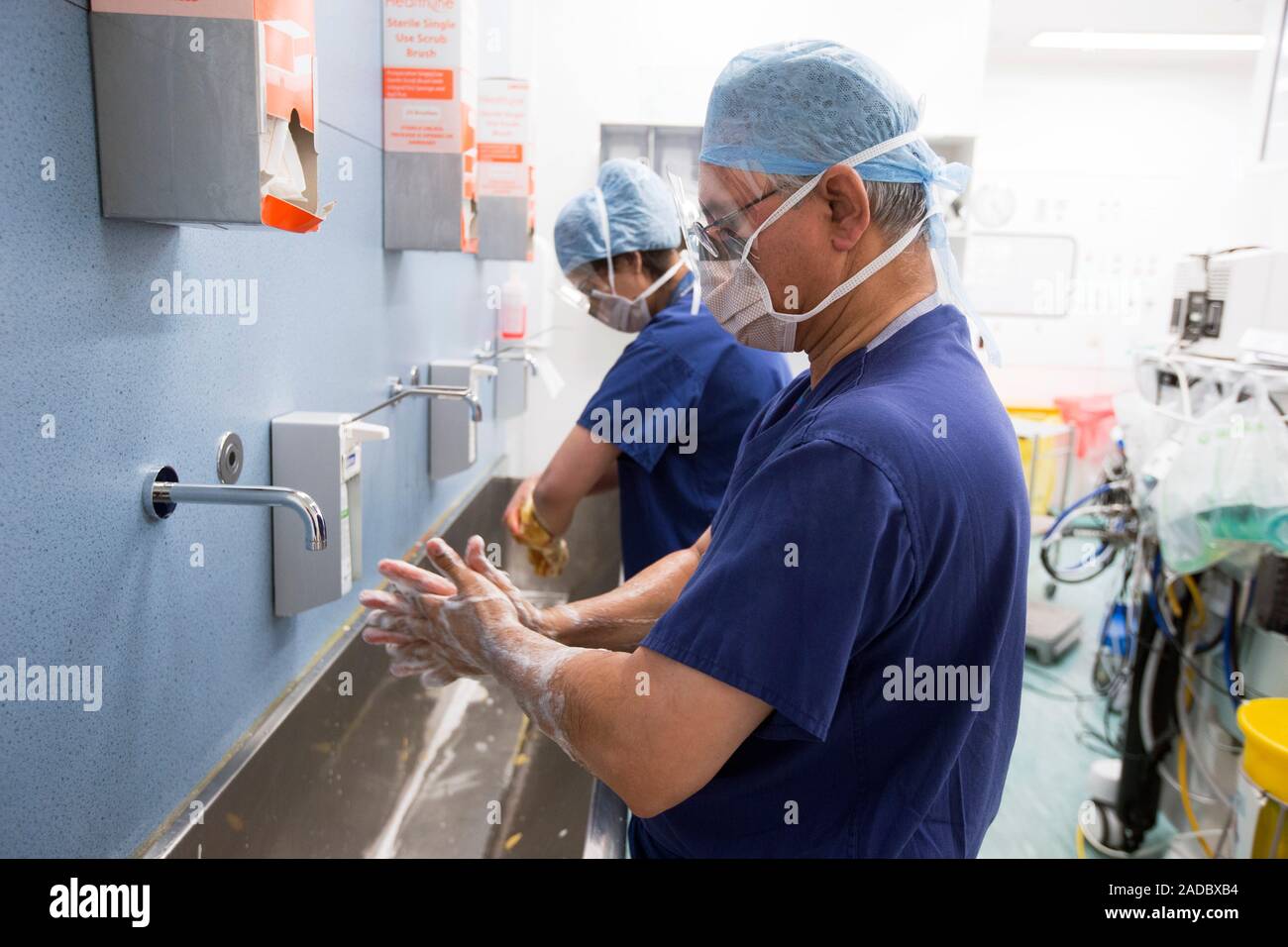 Surgical team 'scrubbing up'. Surgeon and nurse washing their hands and