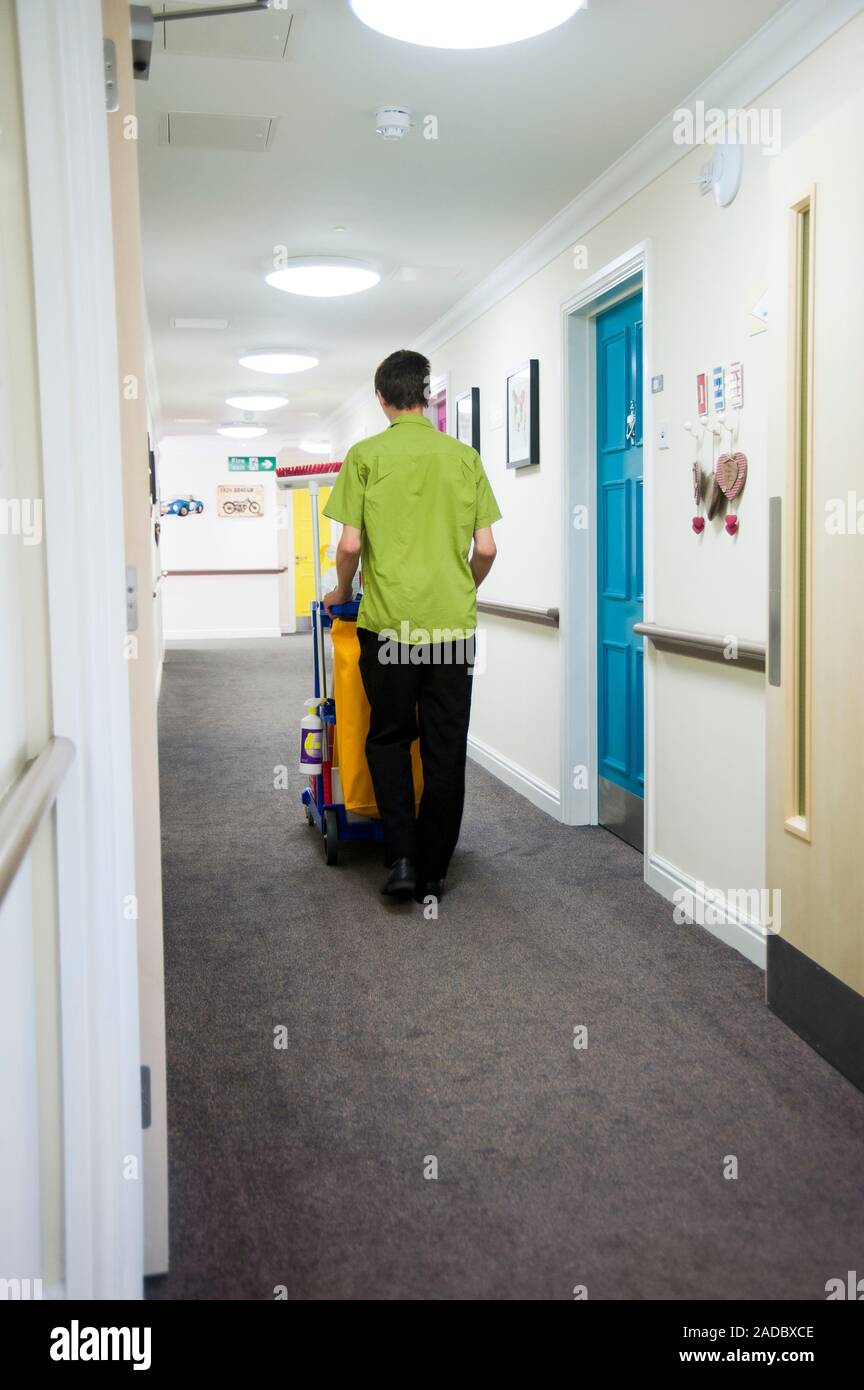 Care home housekeeping. Housekeeper with a trolley of cleaning