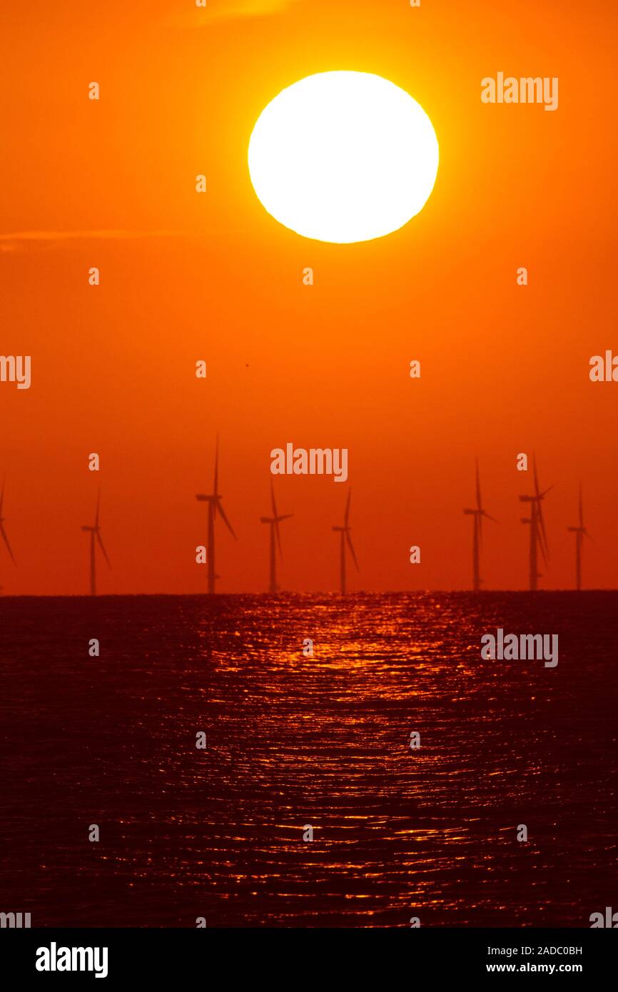 Offshore wind turbines at sunset. Offshore wind farm, generating power ...