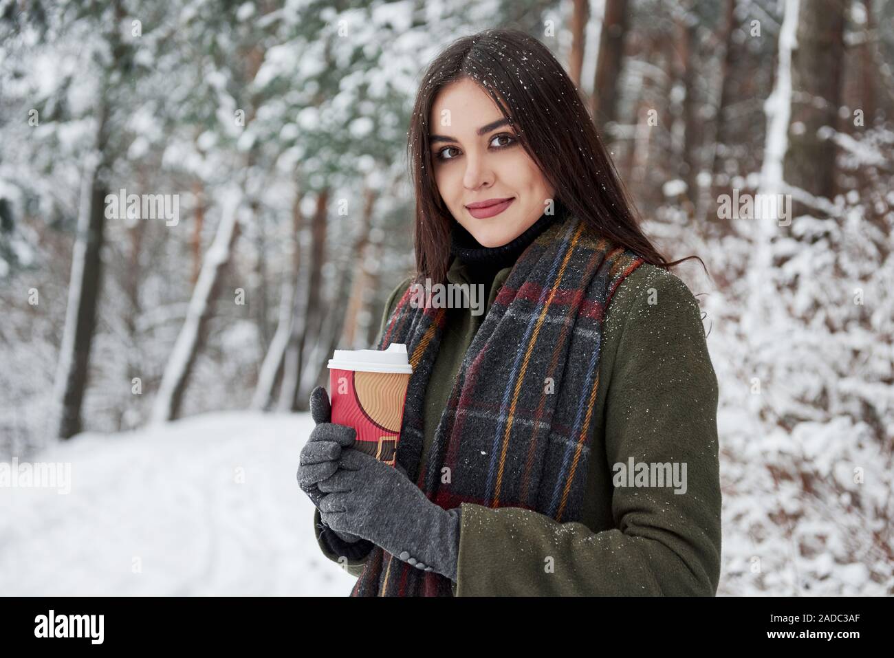 https://c8.alamy.com/comp/2ADC3AF/beautiful-brunette-girl-in-warm-clothes-with-cup-of-coffee-have-a-walk-in-the-winter-forest-2ADC3AF.jpg