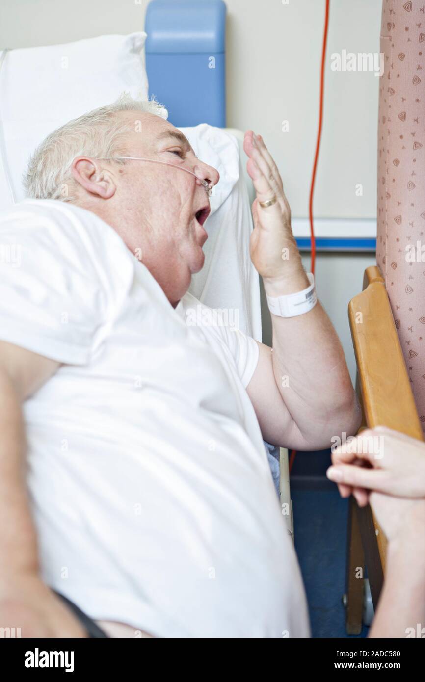 Respiratory physiotherapy patient being taught a coughing method by a ...