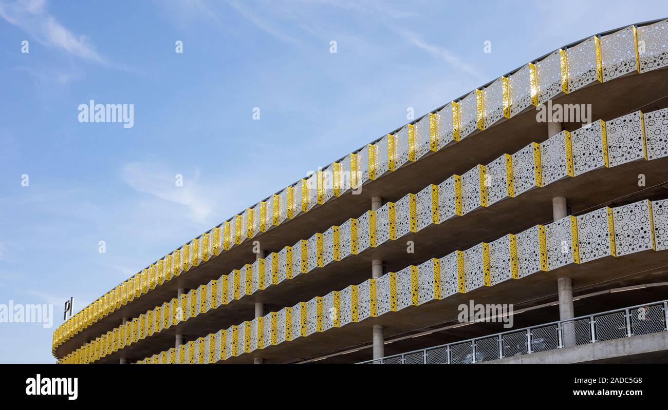 Eindhoven Netherlands. October 14, 2019. Car park multi storey building facade at Eindhoven airport, sunny autumn day. People reflecting on the glass Stock Photo