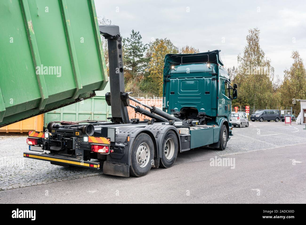 Truck loading container with waste green on recycling center Stock Photo