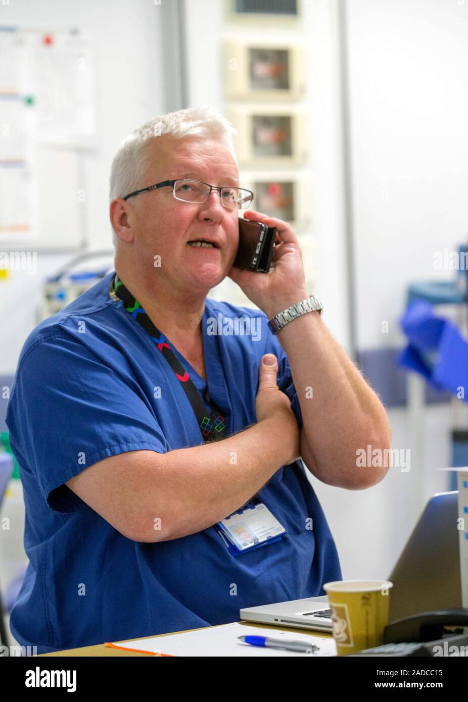 Colorectal cancer surgeon making a phone call in a hospital ...