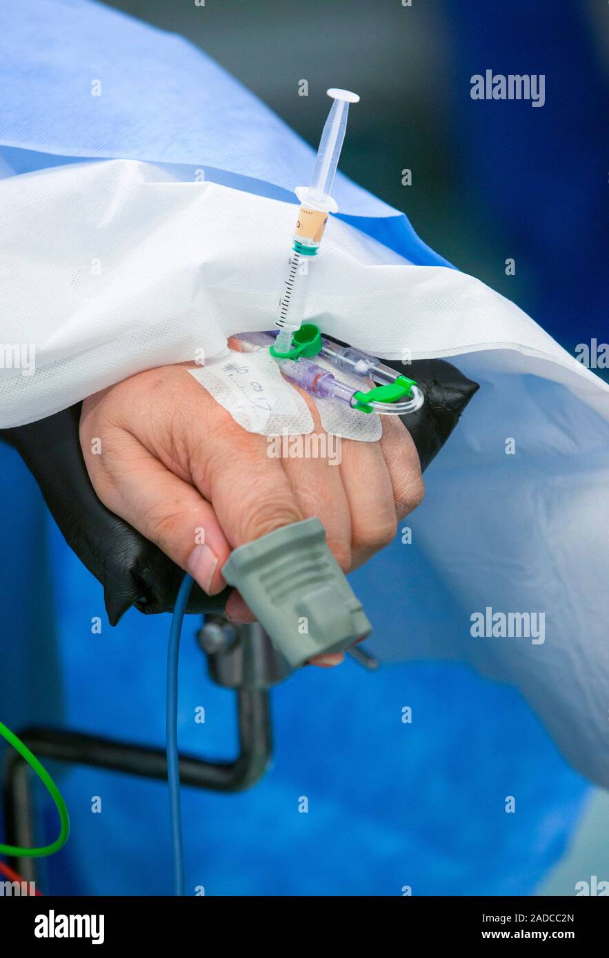 Pulse oximeter use in surgery. Closeup of a catheter and syringe being