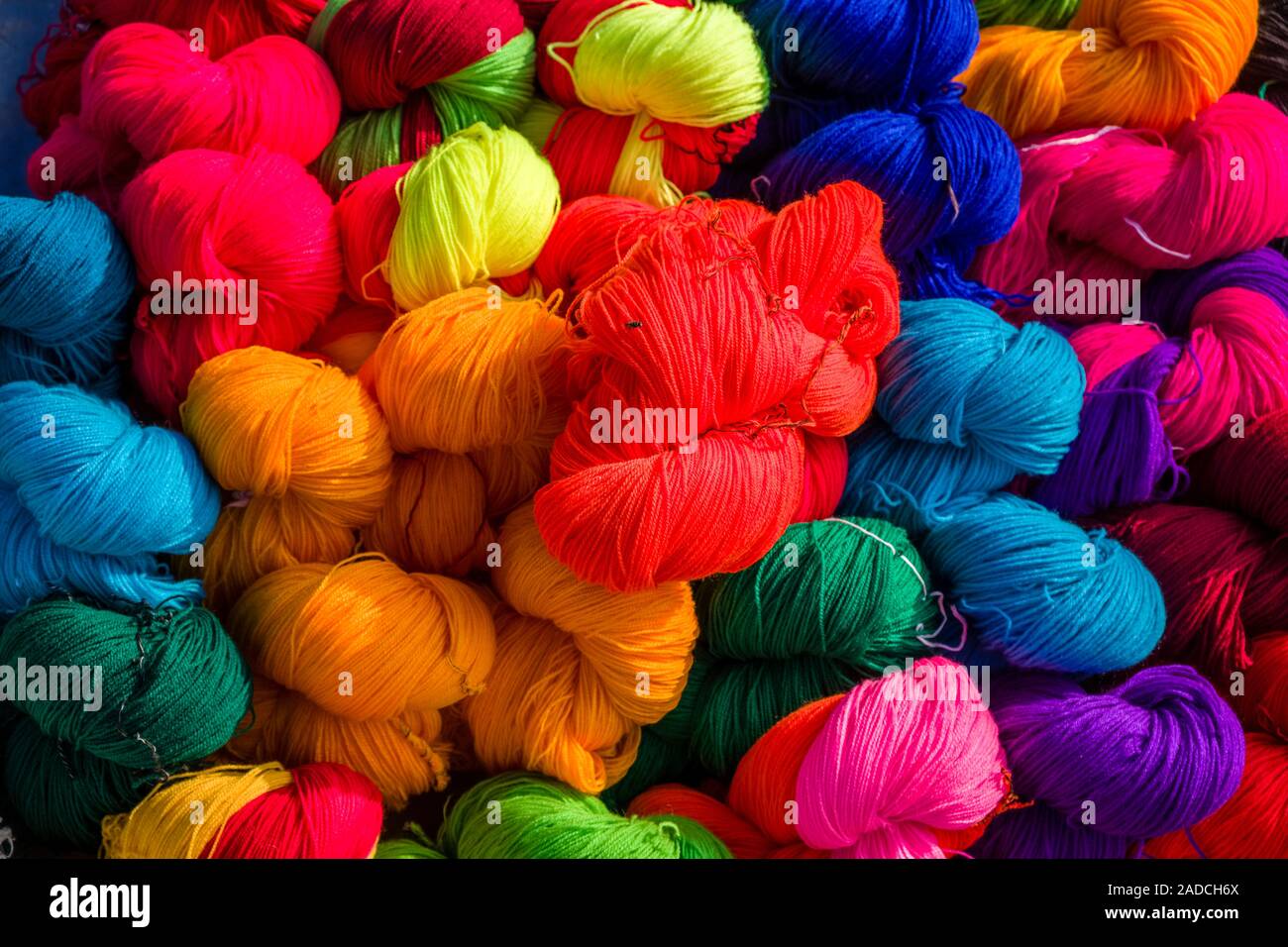 Balls of wool in different colors for sale at the weekly market Stock Photo