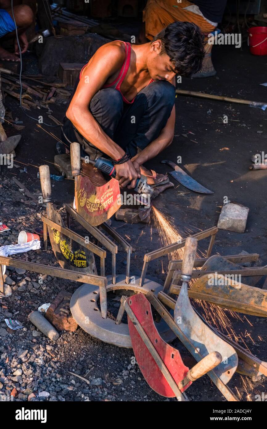 A smith is working with a grinder to sharpen knives Stock Photo Alamy