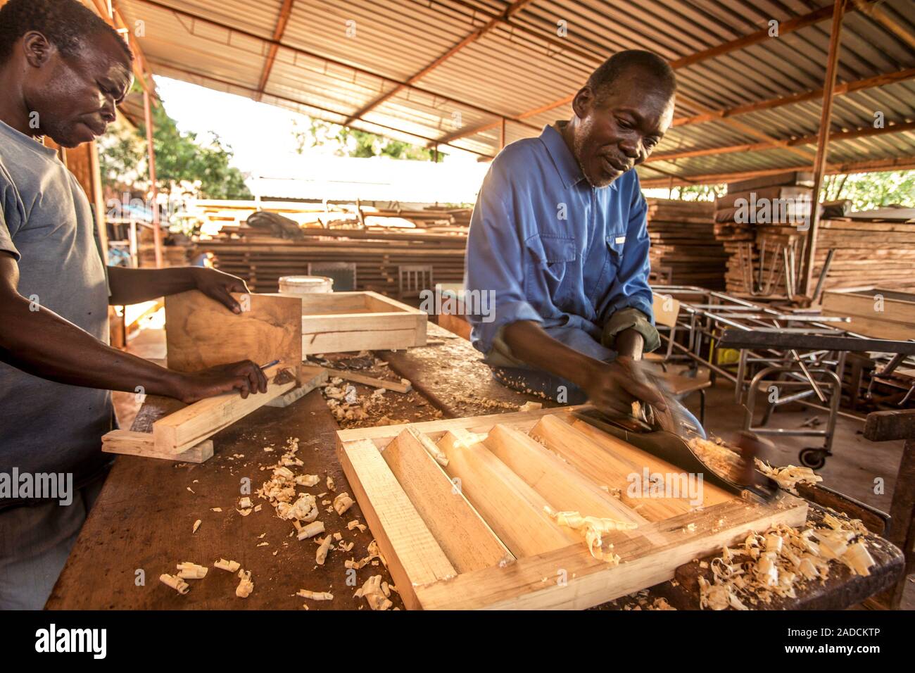 Carpentry work. Wood-working tools being used by carpenters to produce wooden goods. Photographed in Lacor, Gulu, Uganda. Stock Photo