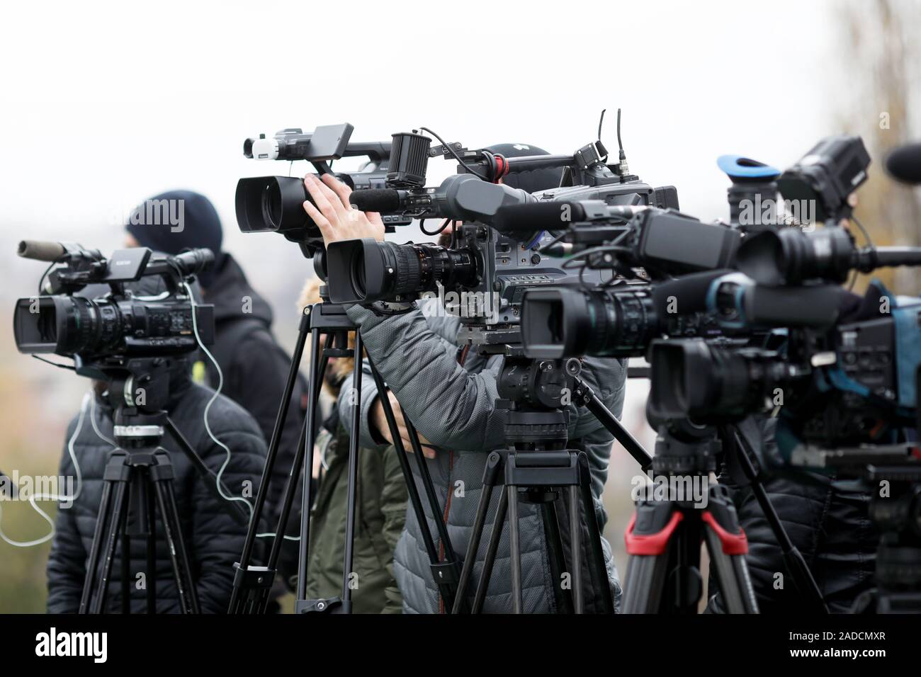 Shallow depth of field image with television video cameras and recording equipment during a press event Stock Photo