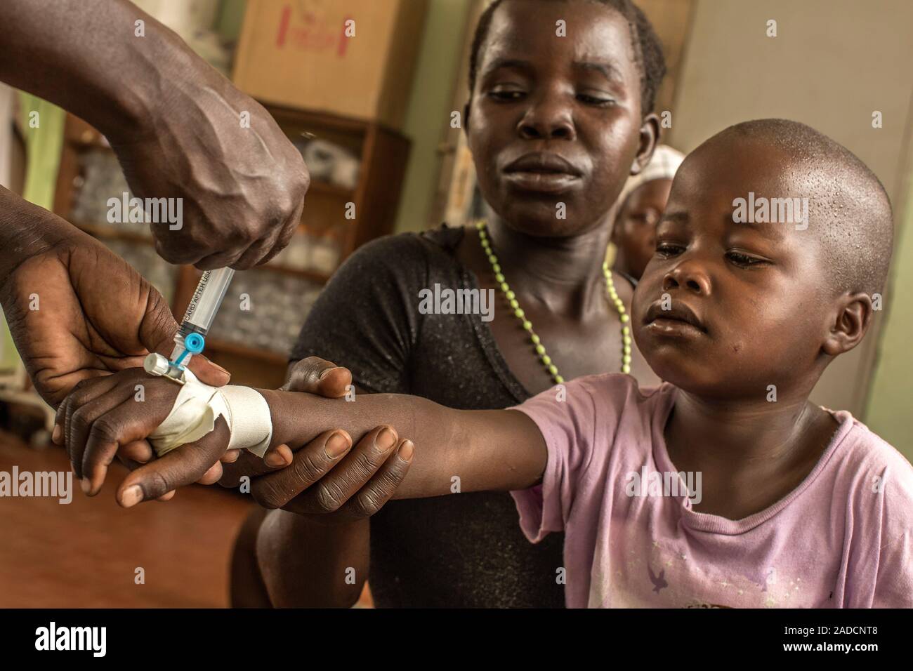 Nurse performing an injection. Boy with his mother, being given an ...