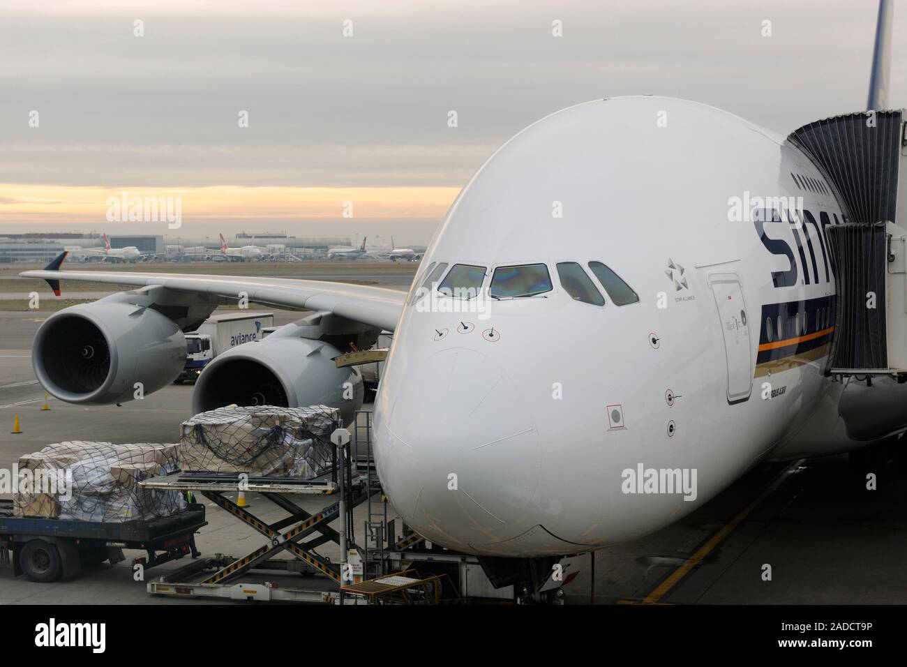 Cargo being loaded from a truck and low-loader onto a Singapore ...