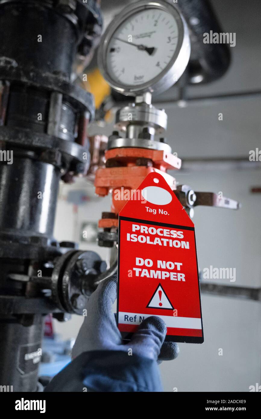 Stock Images Process Isolation CalaChem chemical factory. Worker looking at a process isolation tag at ...