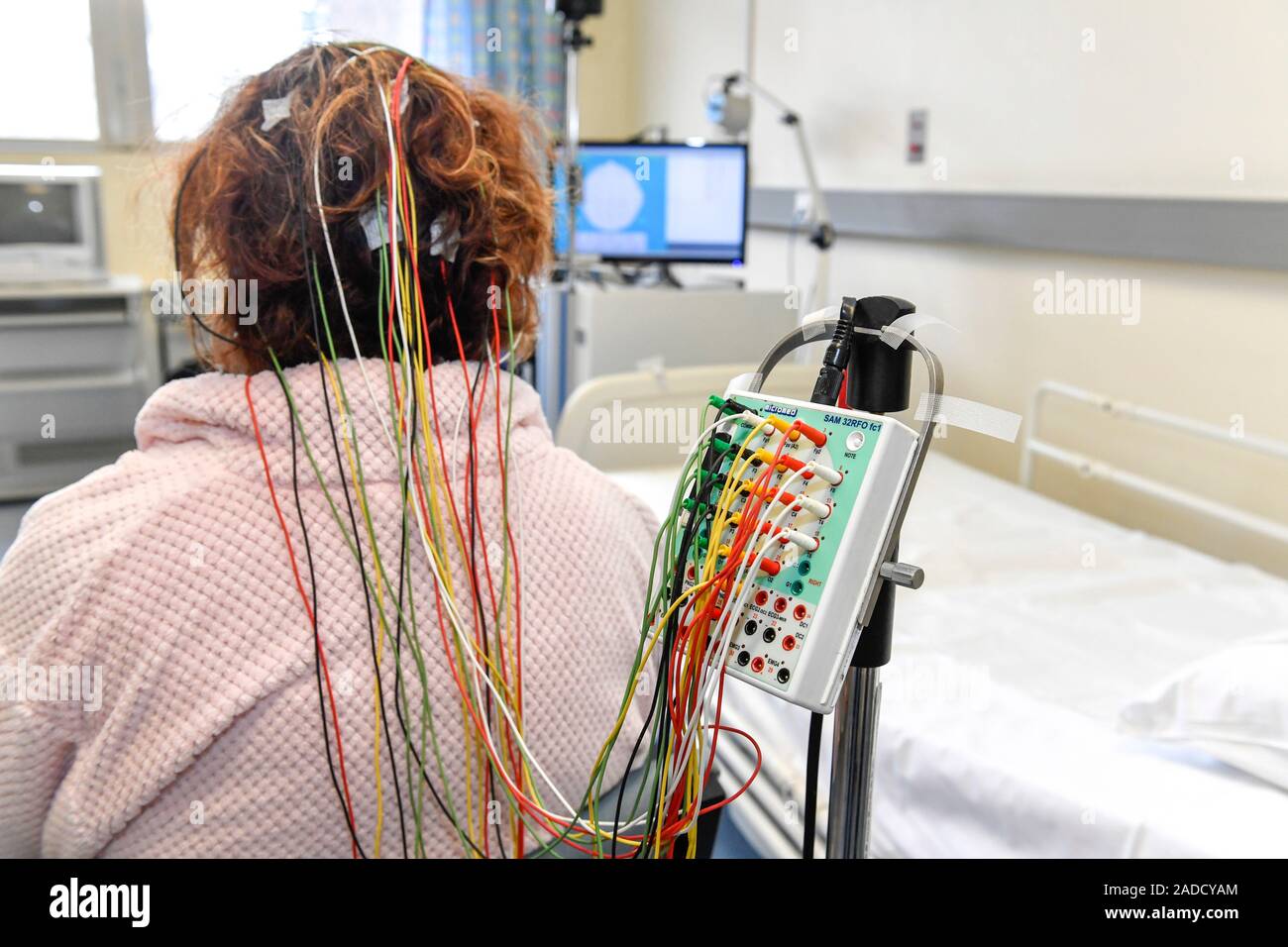 Electroencephalography Woman with electrodes attached to her head as