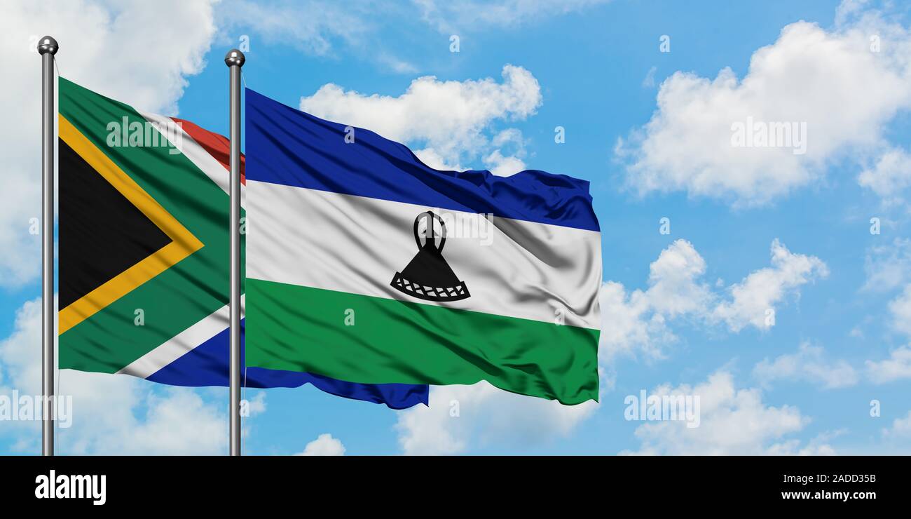 South Africa and Lesotho flag waving in the wind against white cloudy ...