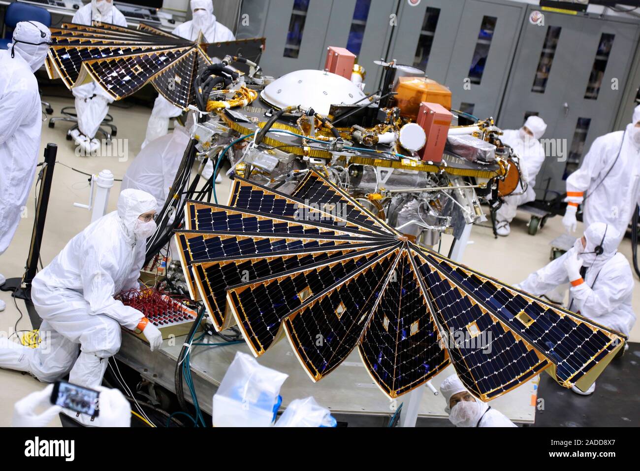 InSight Mars lander solar array test. Engineers and technicians testing the solar array for NASA's Insight Mars lander. They are performing an illumin Stock Photo