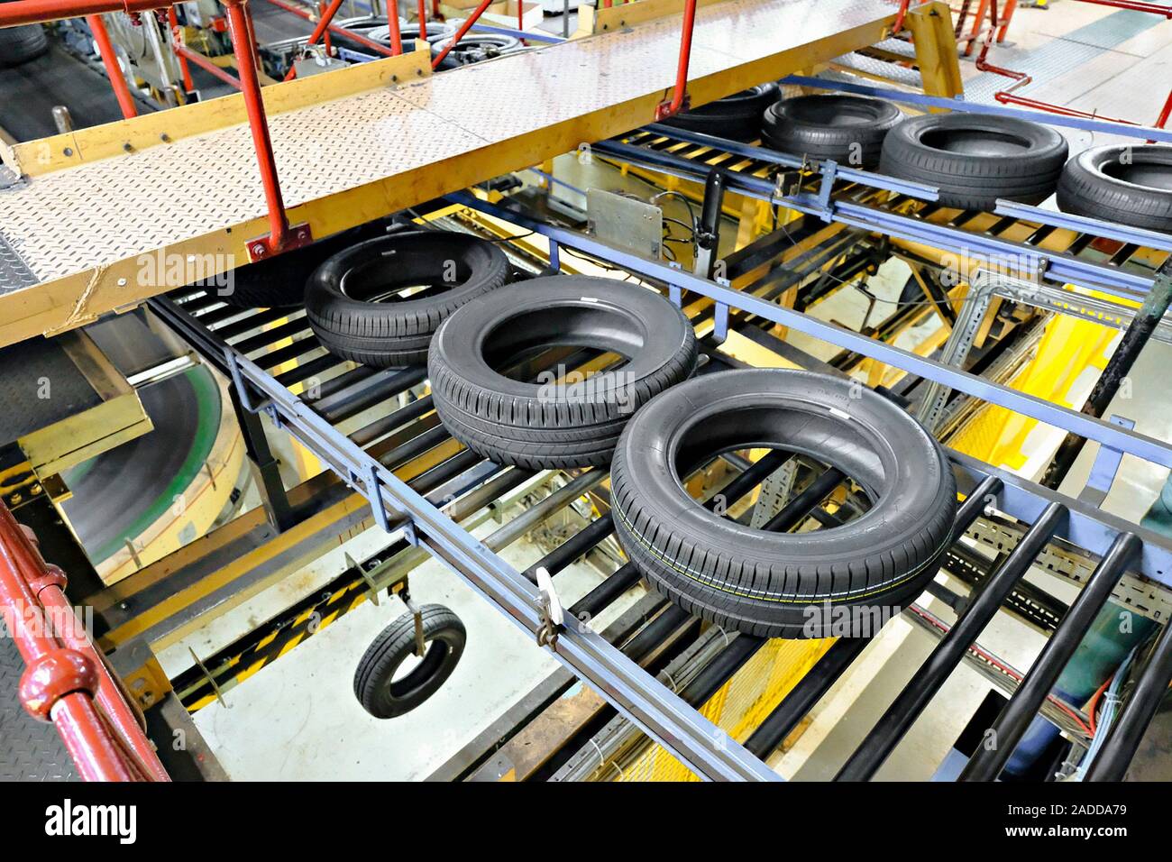 Tyre factory. Finished tyres on a conveyor belt at a factory that makes