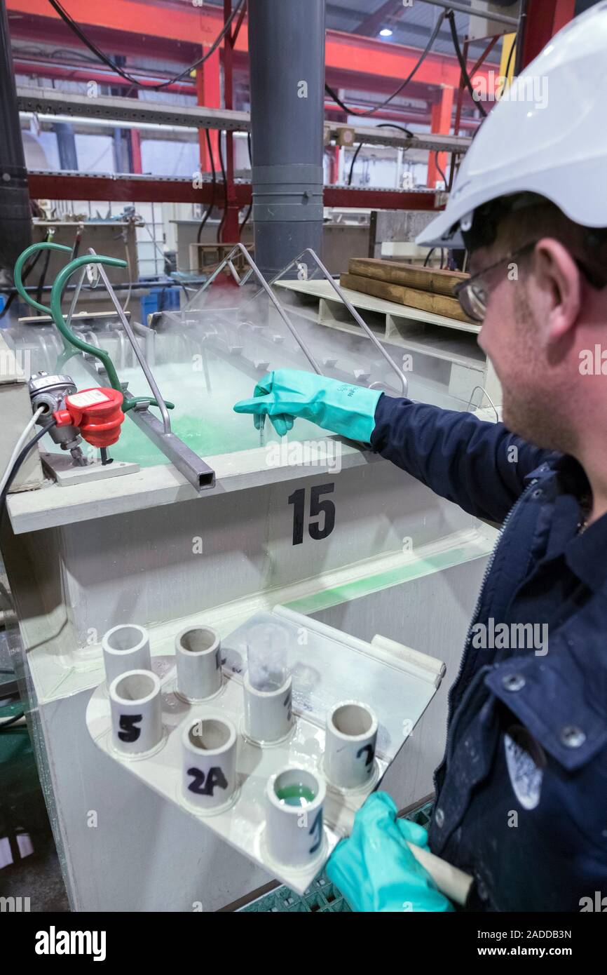 Electroless nickel plating factory. Worker checking the chemical
