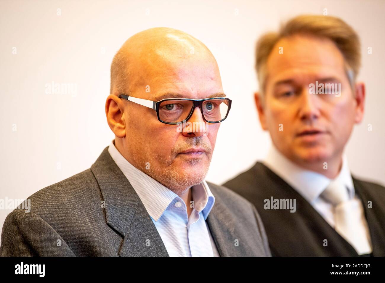 Detmold, Germany. 04th Dec, 2019. The defendant Rolf Herbrechtsmeier (l) and his defender Carsten Ernst stand side by side in the courtroom. The public prosecutor's office in Detmold accuses the accused of 'driving licence king' Herbrechtsmeier of 505 cases of fraud which allegedly led to a total loss of almost 650,000 euros. Credit: David Inderlied/dpa/Alamy Live News Stock Photo