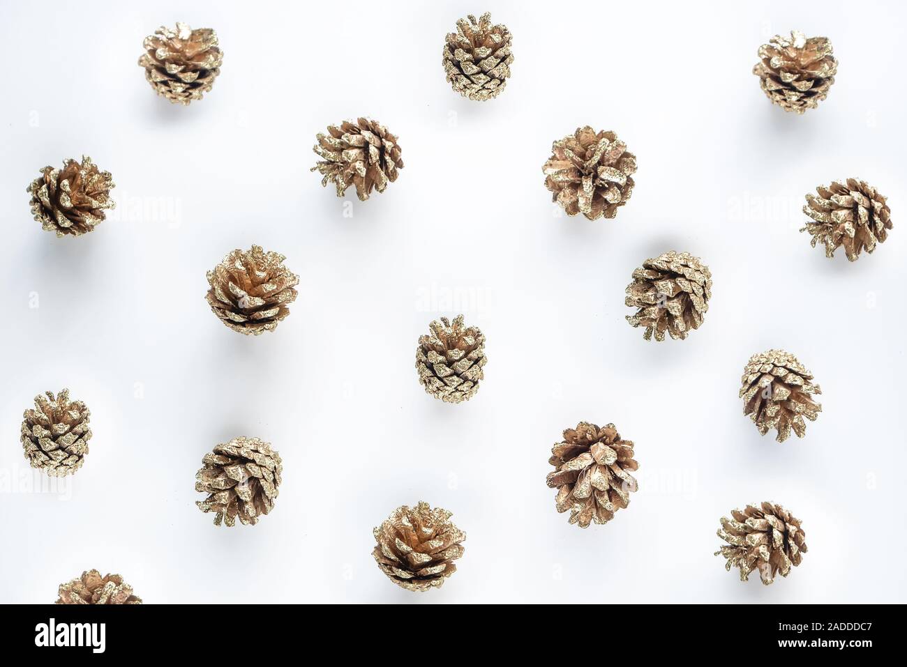 golden pine cone pattern background isolated on white for Christmas or winter seasonal Stock Photo